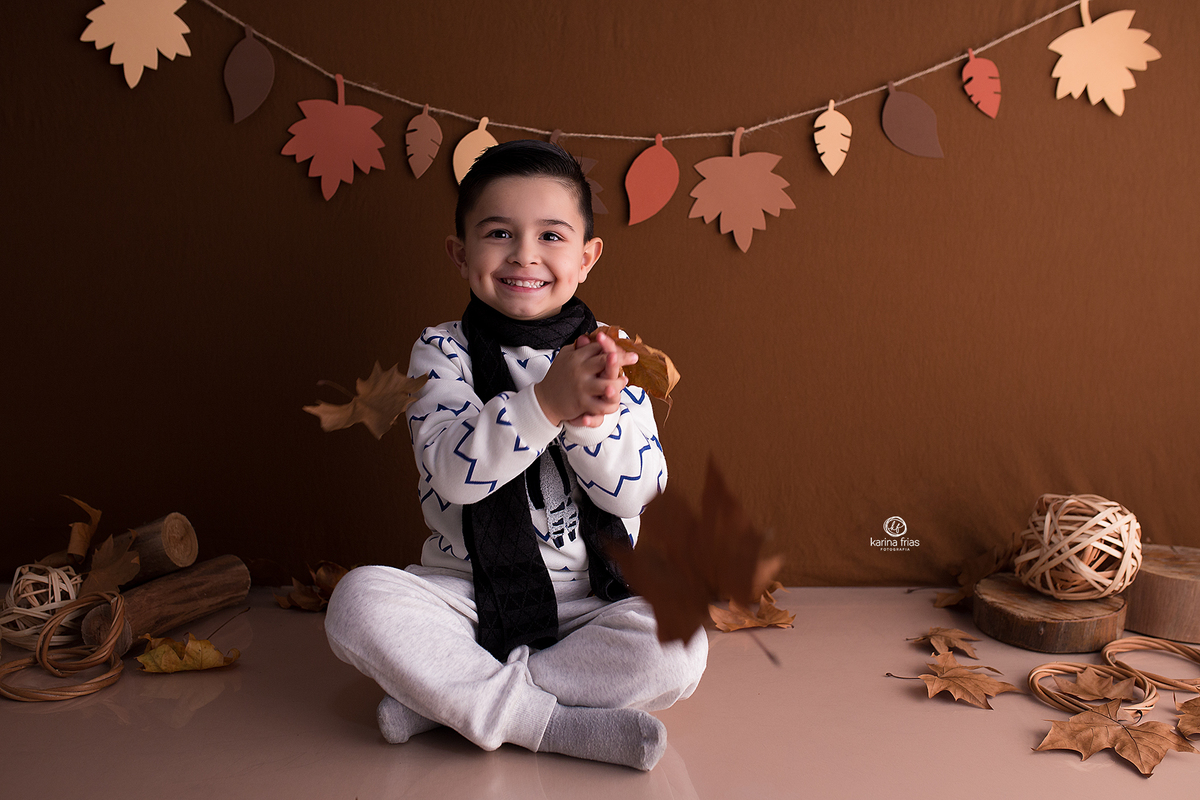 no ensaio infantil jogamos folhas na criança