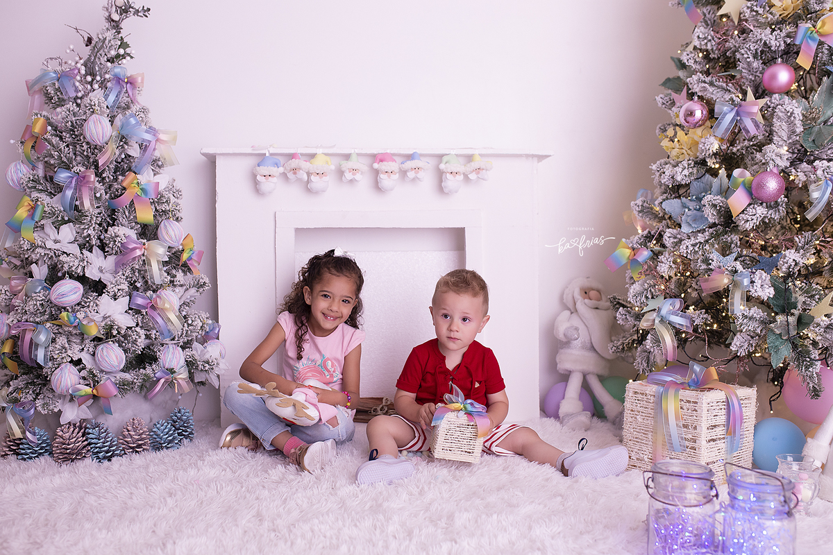 o menino brinca com a prima no cenario de natal 2021