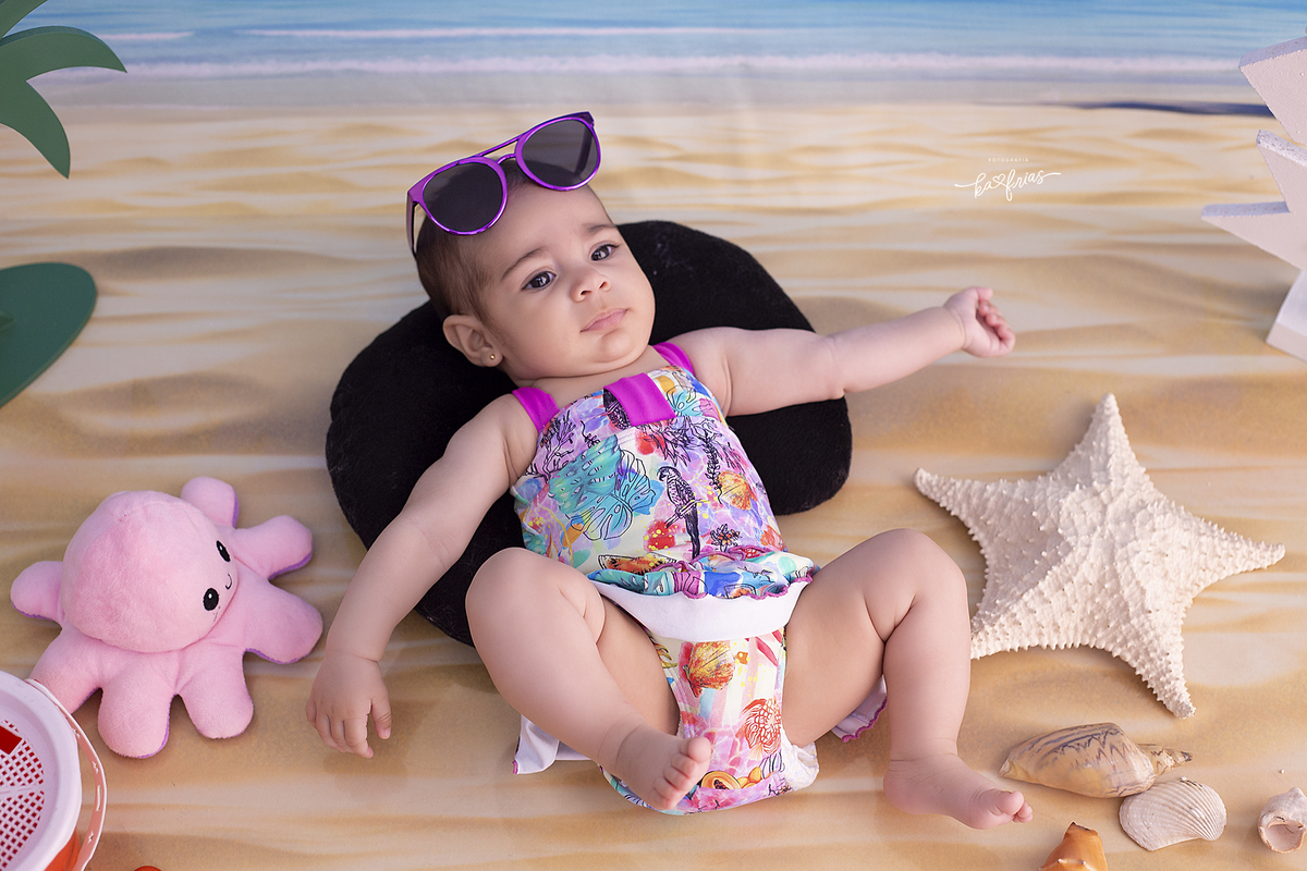 a menina esta deitada no cenario de praia