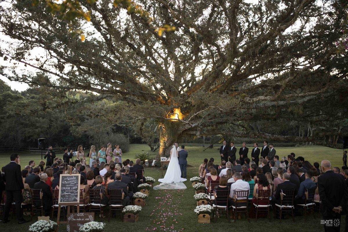casamento ao ar livre em baixo da figueira alto da capela porto alegre entrada da noiva vestido marco tarrago traje franzn alfaiataria decoracao cor de perola fotografo de casamento no brasil