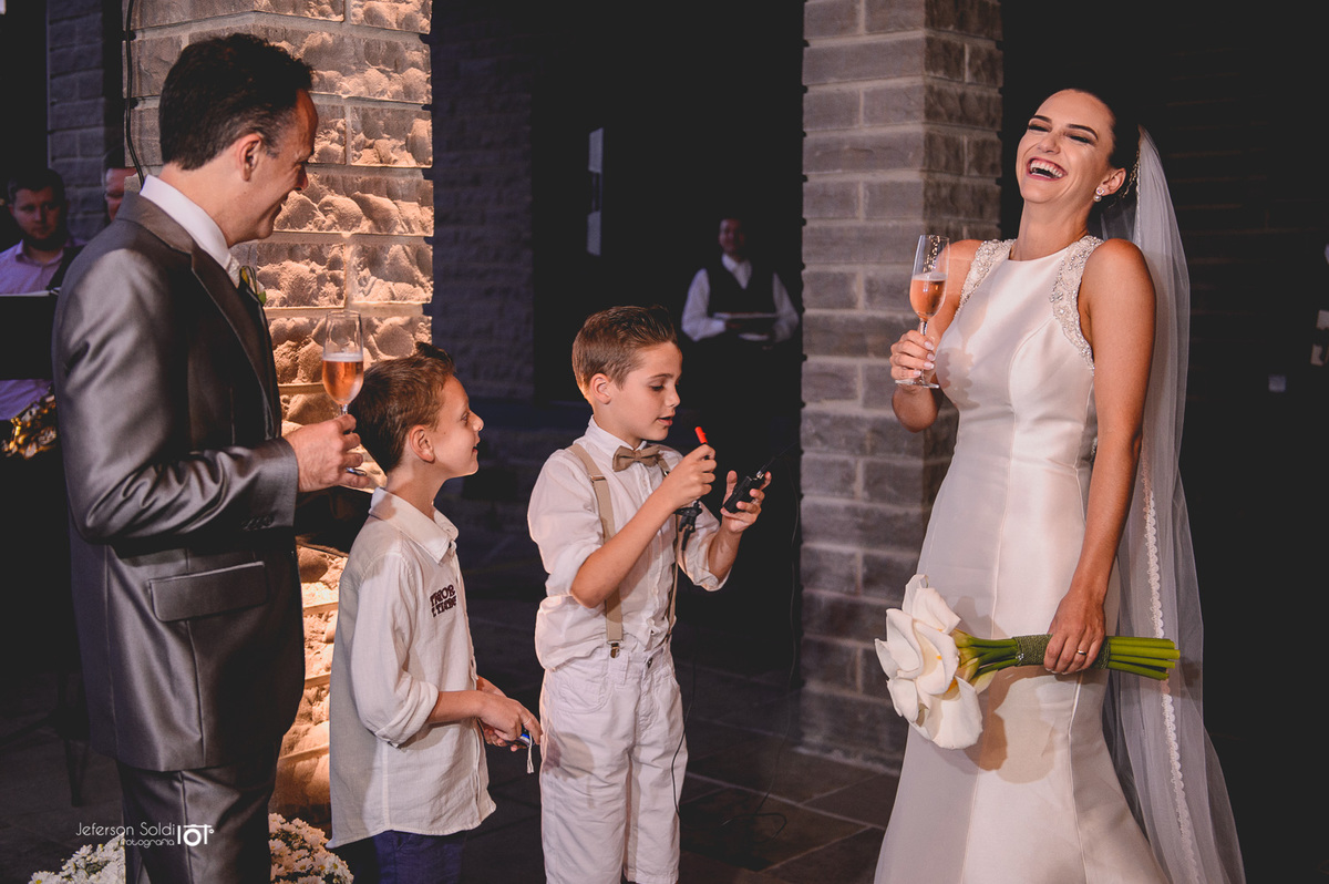 Noiva sorrindo ao chegar no local da recepção.