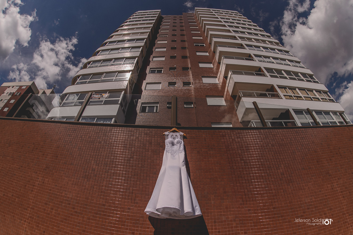 Vestido da noiva suspenso na fachada do predio da estética.