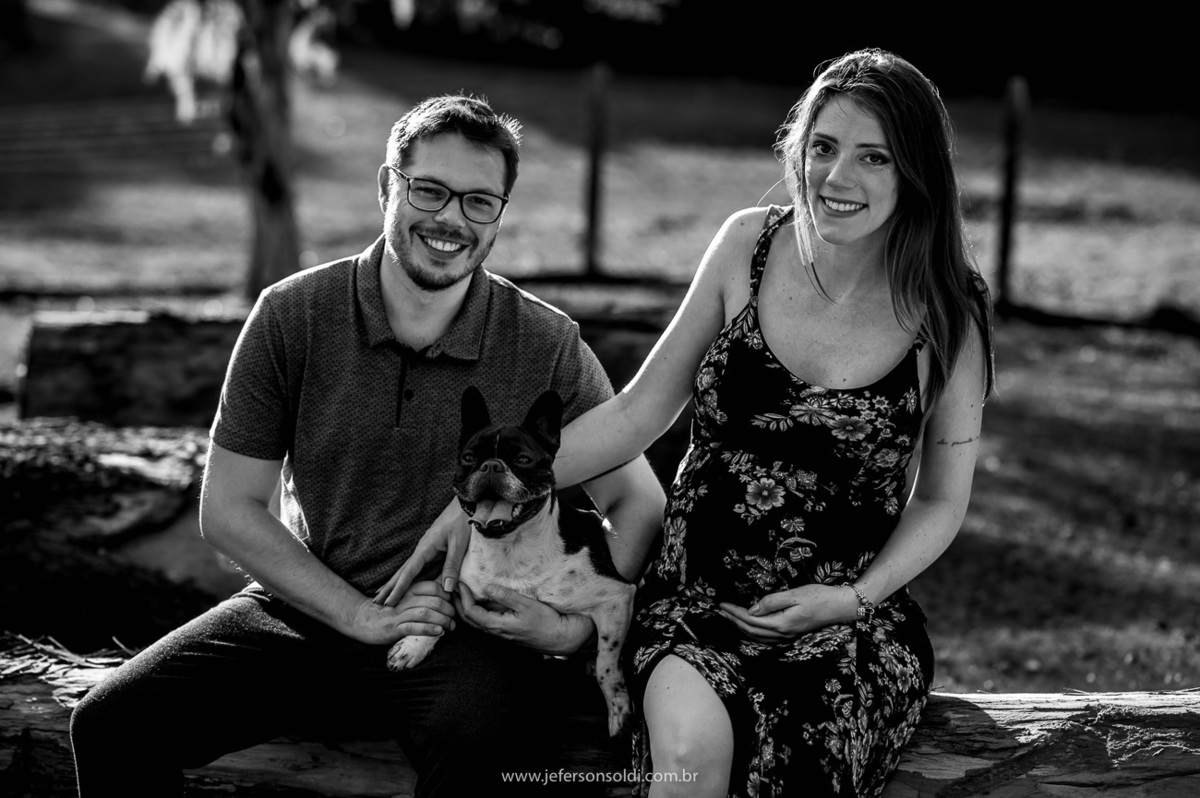 Casal de gravidos pousando para foto com e seu lindo e tbm membro da família um buldogue francês e uma foto preto e branco