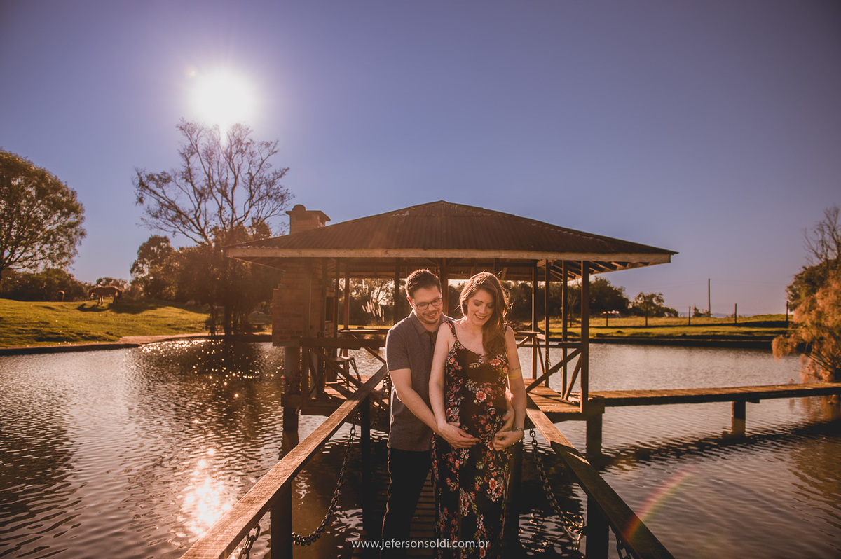 casal gravido sorrindo e uma foto linda de final de tarde