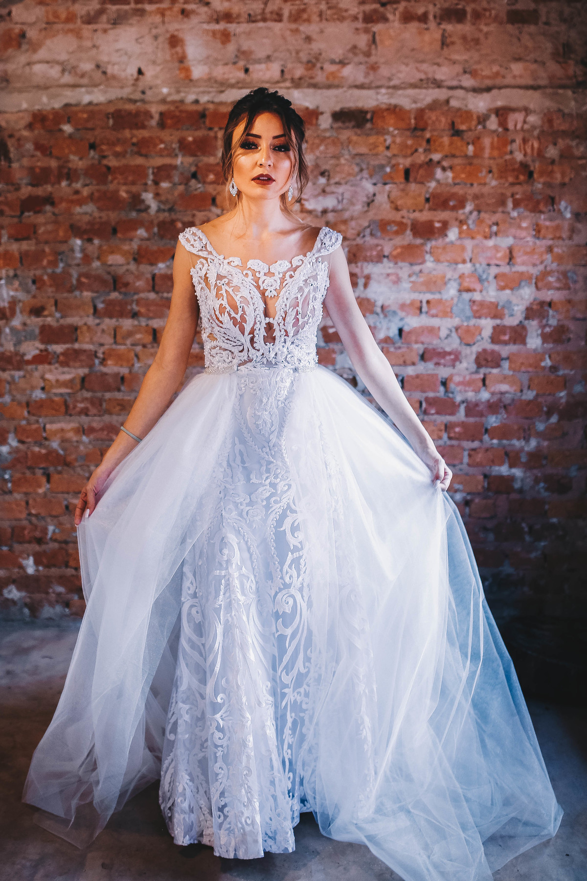 vestido branco em frente a parede de tijolos