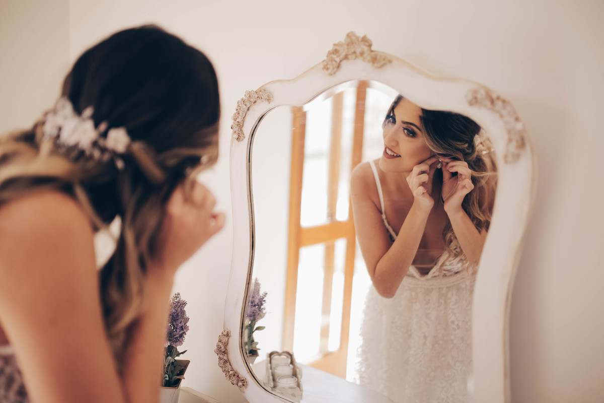 mulher colocando brinco 