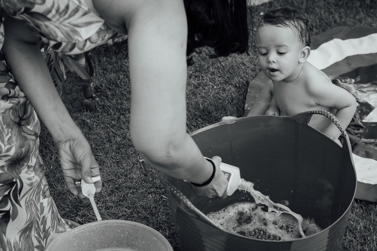 Bebê olhando a mamãe prepara o banho