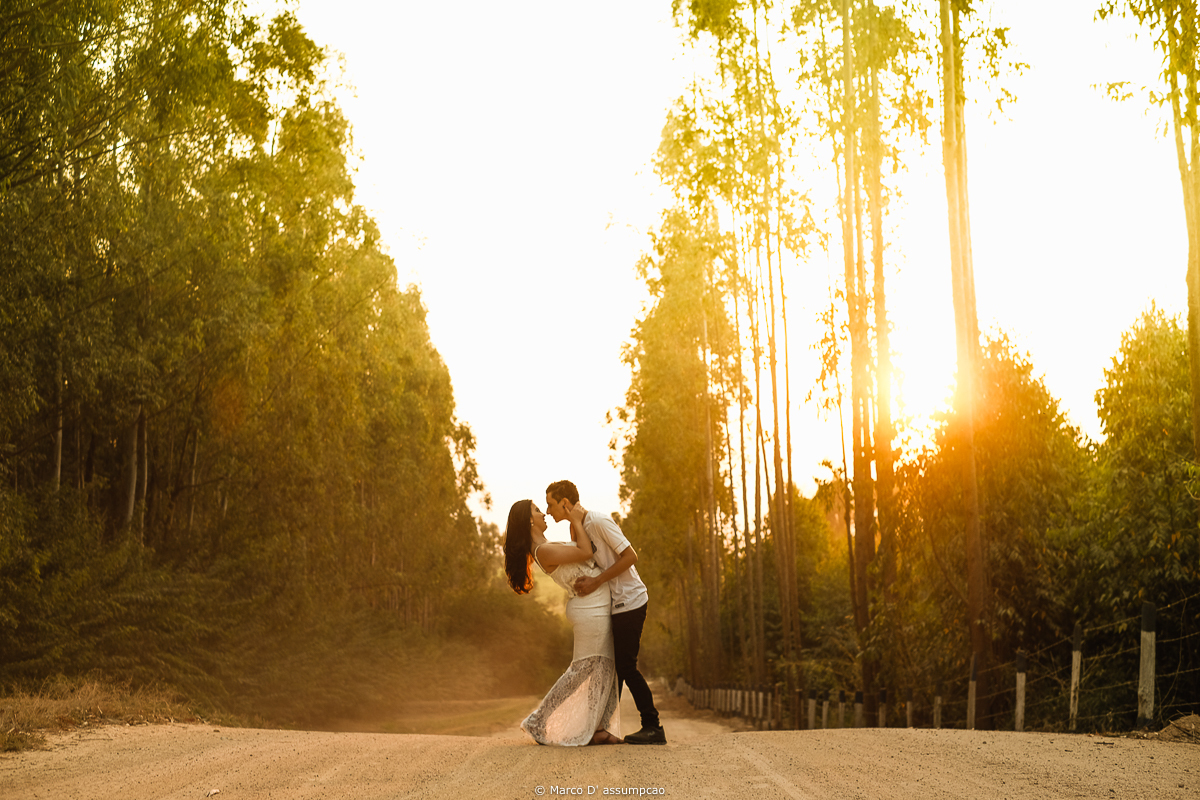casal abracados na estrada de terra com por do sol