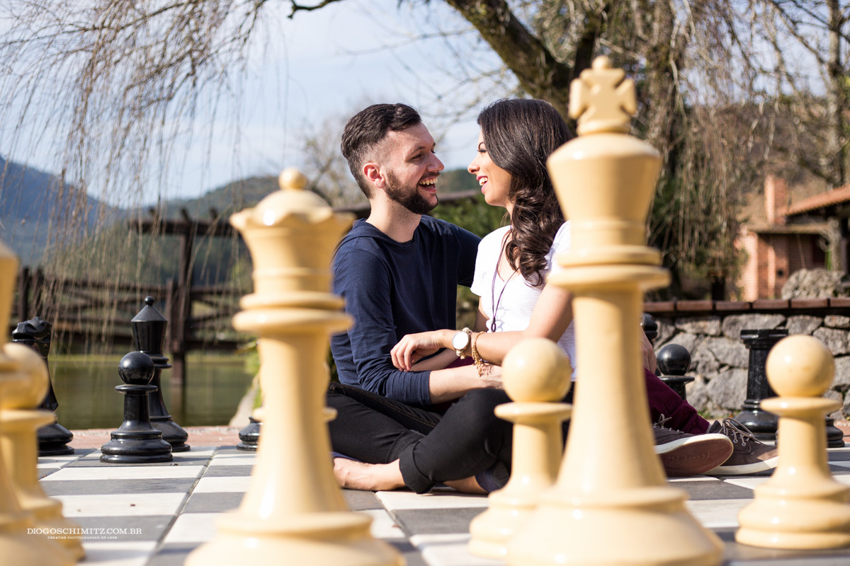Casal se divertindo em um tabuleiro de xadrez