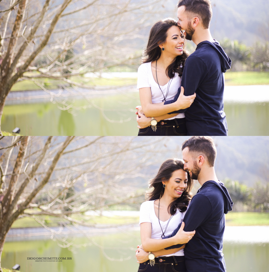 Casal se abraçando em frente a um lago.