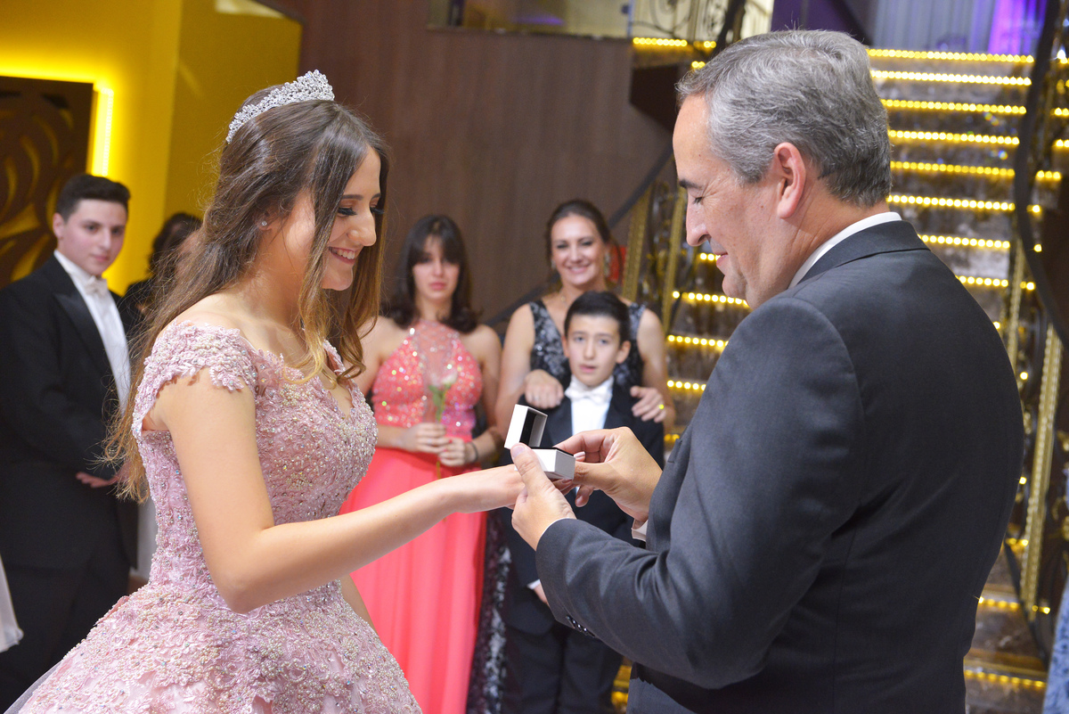 fotografia da debutante Marina recebendo o presente do pai durante o cerimonial de valsa realizado no buffet East Side