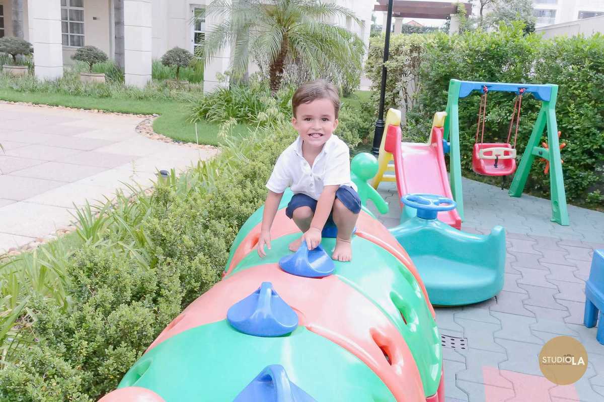 Fotografia de festa infantil em São Paulo feita pelo Studio LA. O aniversariante brinca alegremente em meio aos convidados, registrando a espontaneidade e os momentos únicos da infância.