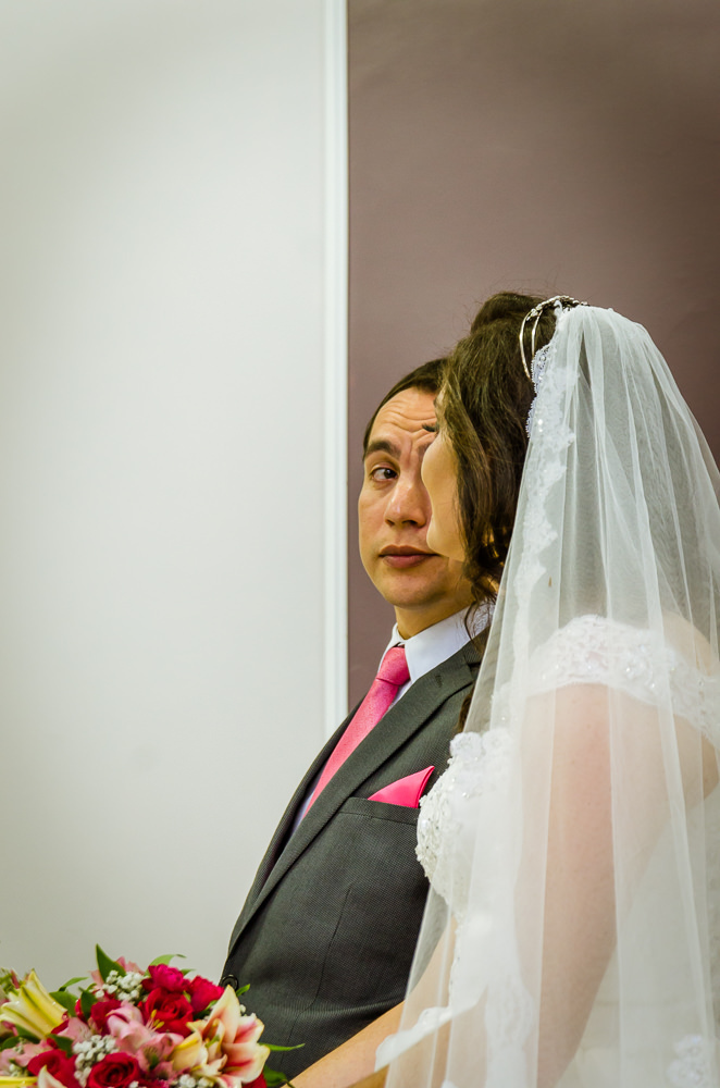 Foto da cerimônia de casamento no Salão do Reino das Testemunhas de Jeová, JW, em Santa Maria, RS. Orador do discurso de casamento, noivos sentados se olhando.