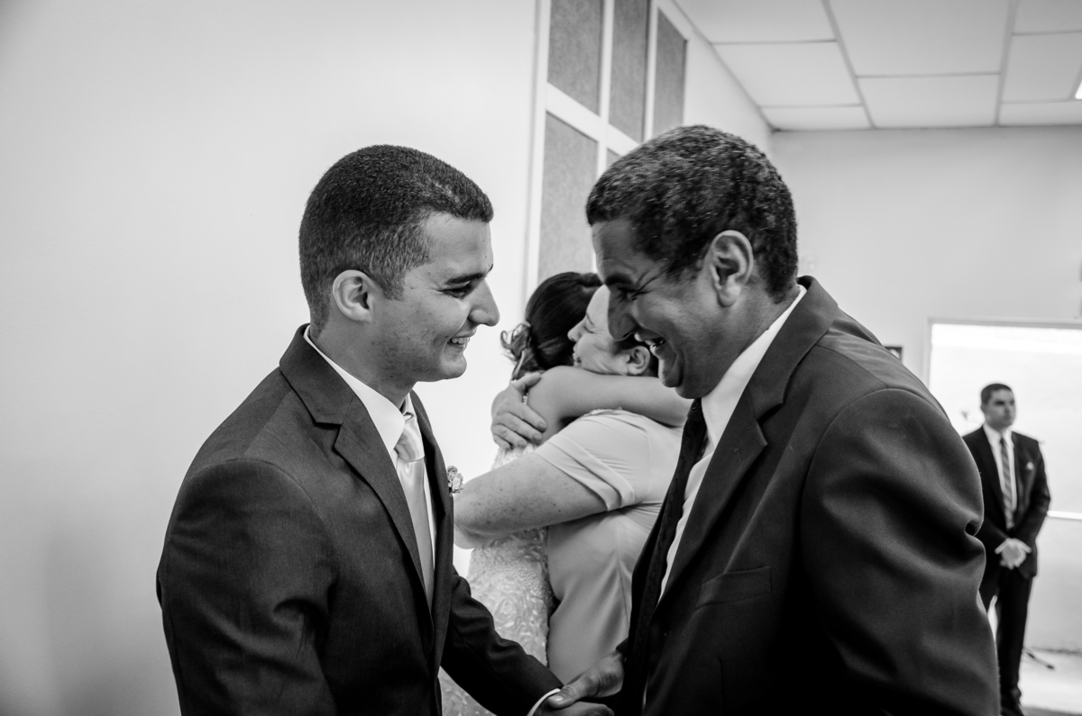 Foto após a cerimônia de casamento em Preto e Branco, WB, PB, dos pais do noivo abraçando o filho com ternura em Cajamar, São Paulo
