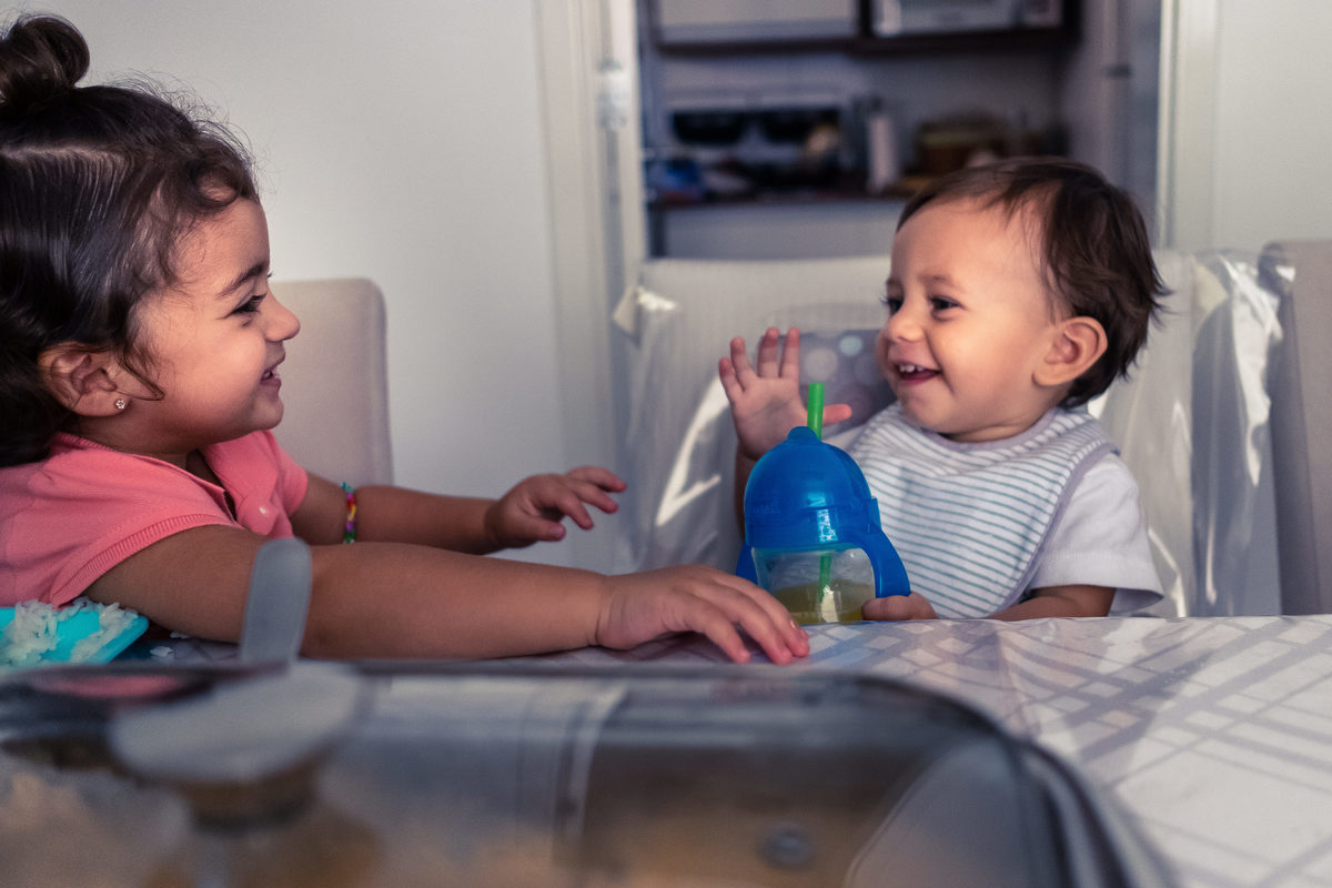Fotografia Documental de Família em Cotia, Granja Viana, São Paulo, família Galli com filho, bebê, criança de um ano de idade. Momentos em família no café da manhã e brincando com as crianças com água. Bateria completa com os filhos.