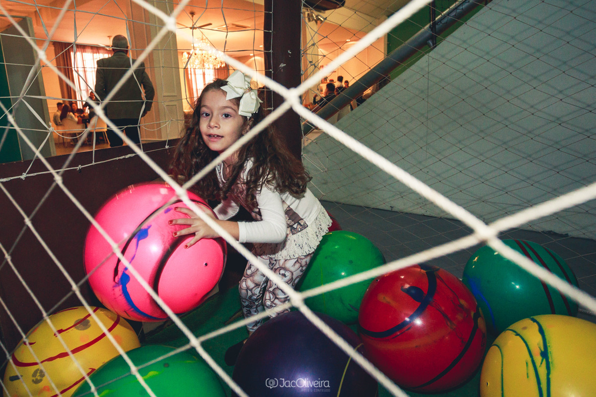 menina brincando no aniversario com bolas gigantes