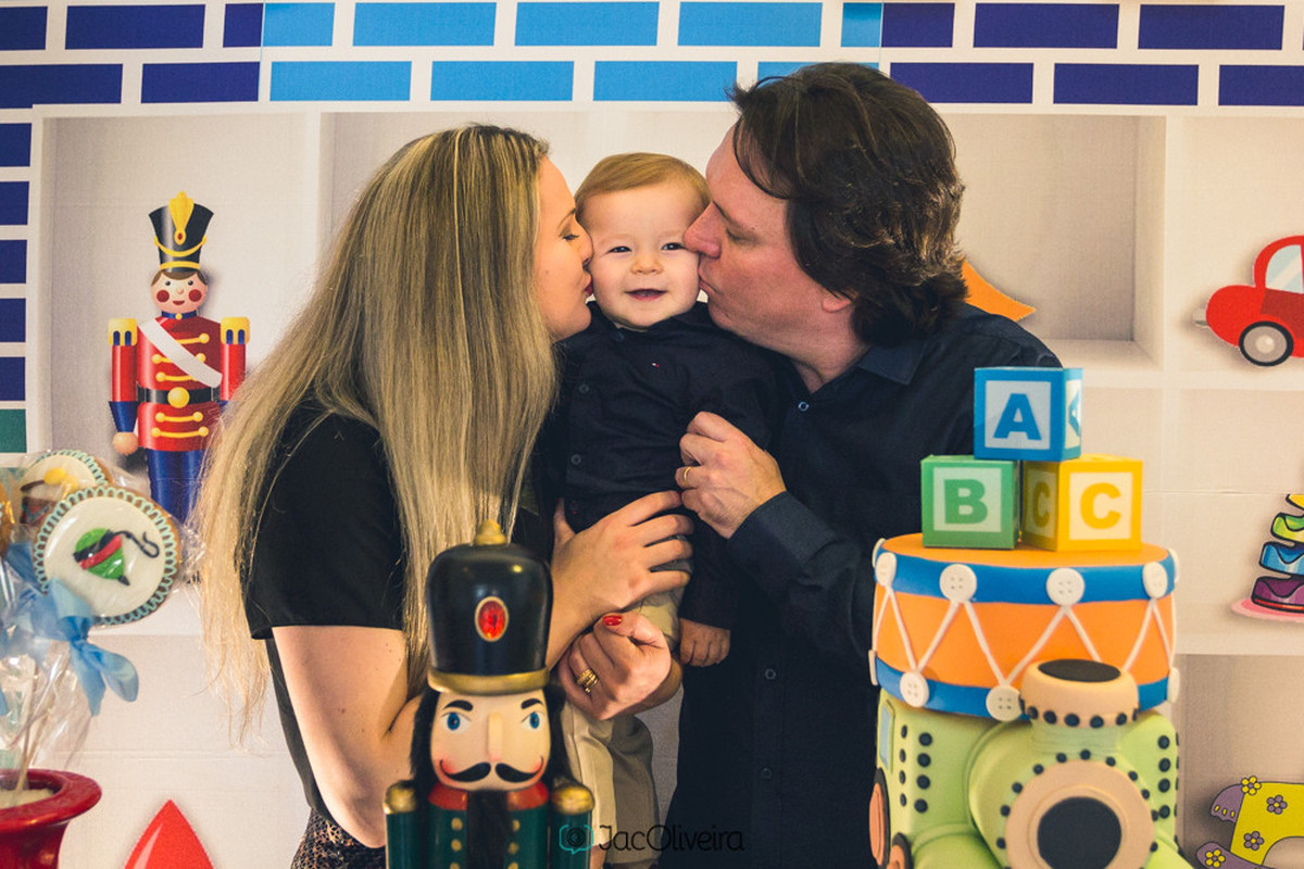 fotos do bebê com pais na mesa de bolo brinquedos