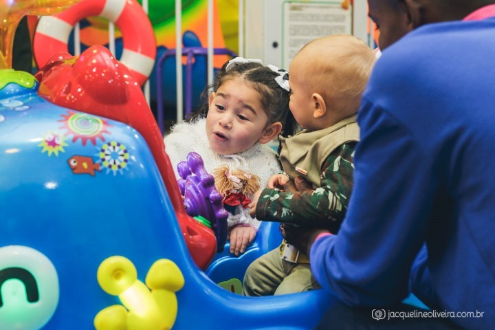 menina e menino brincando no brinquedo