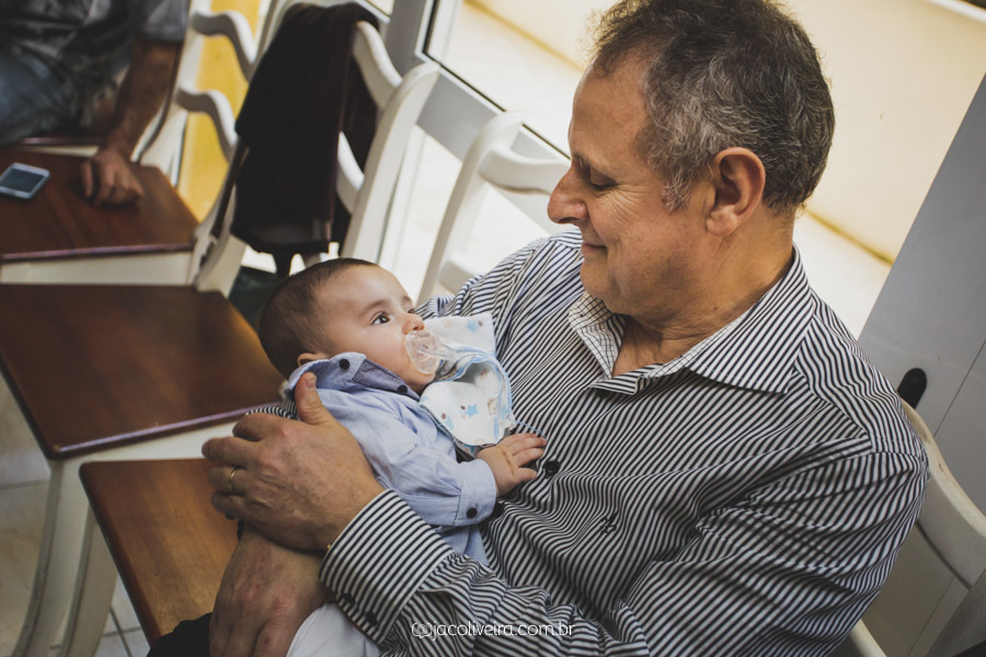 bento no colo do avô no dia do batismo porto alegre