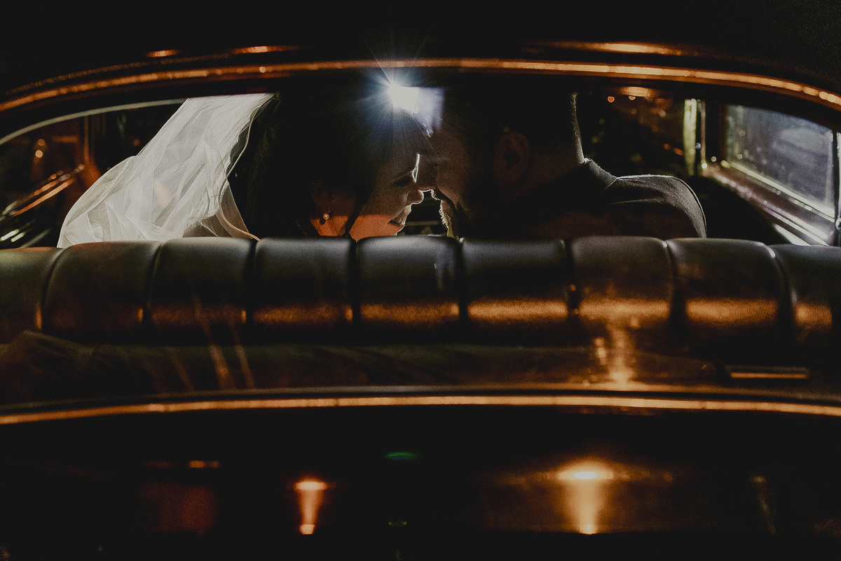 a fotografia do ensaio dos noivos no carro antigo que levou a noiva at´o casamento fotografo pelo renomado fotografo premiado com varios premios de fotografia