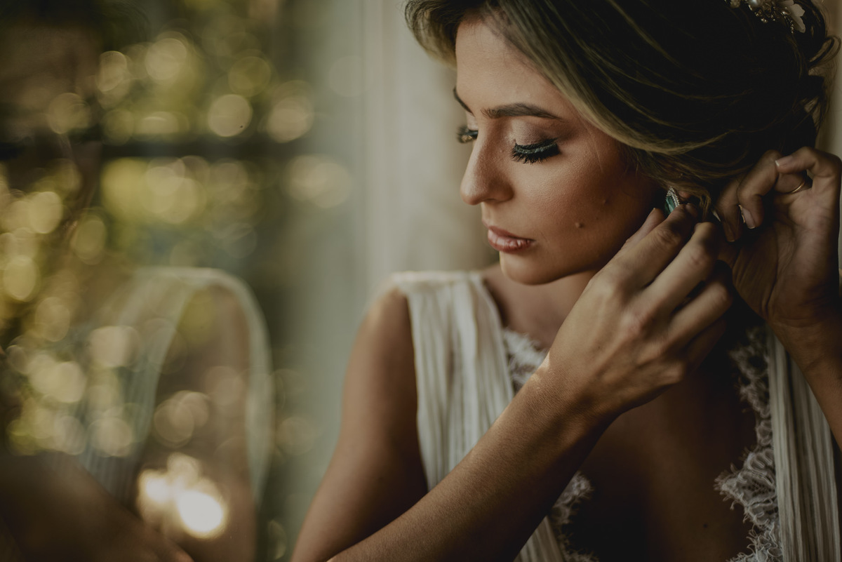 a linda noiva colocando seus brincos momentos antes do casamento no campo espaço villa sansu 