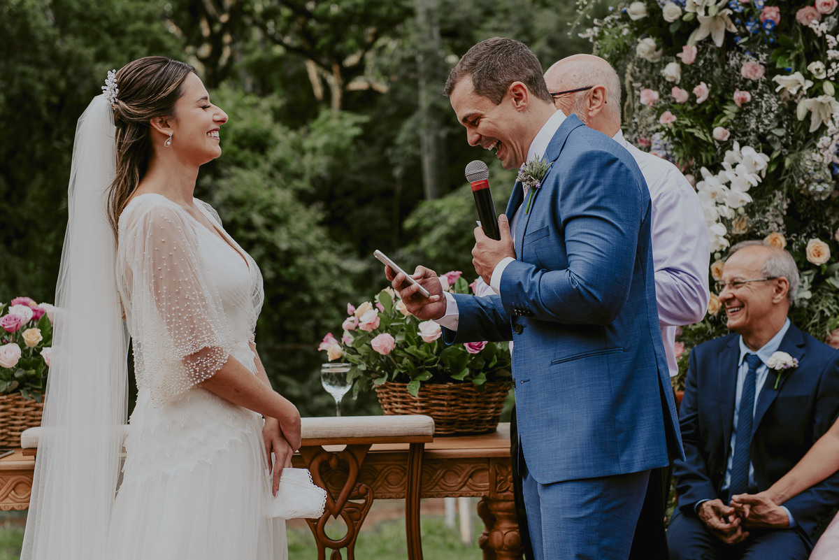 foto do daniel okuyama da noiva se divertindo com os votos do seu noivo durante a cerimônia de casamento no campo foto de casamento espontânea