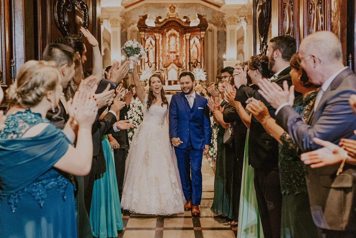 os convidados aplaudem os noivos ao final da cerimonia de casamento na capela da puc sp pelo melhor fotografo de casamento daniel okuyama