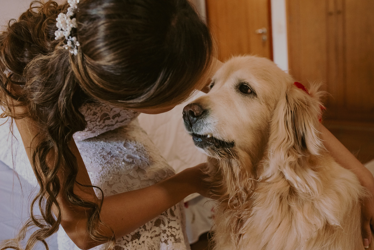 um amor e carinho da noiva com sua cachorra no dia do casamento que sera realizado ao ar livre em uma fazenda