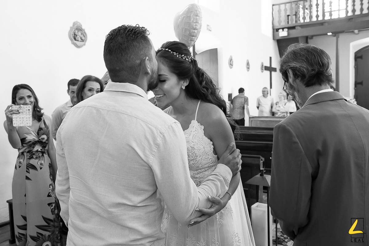 Noivo beijando a noiva na testa em foto preto e branco por Leal Fotografias