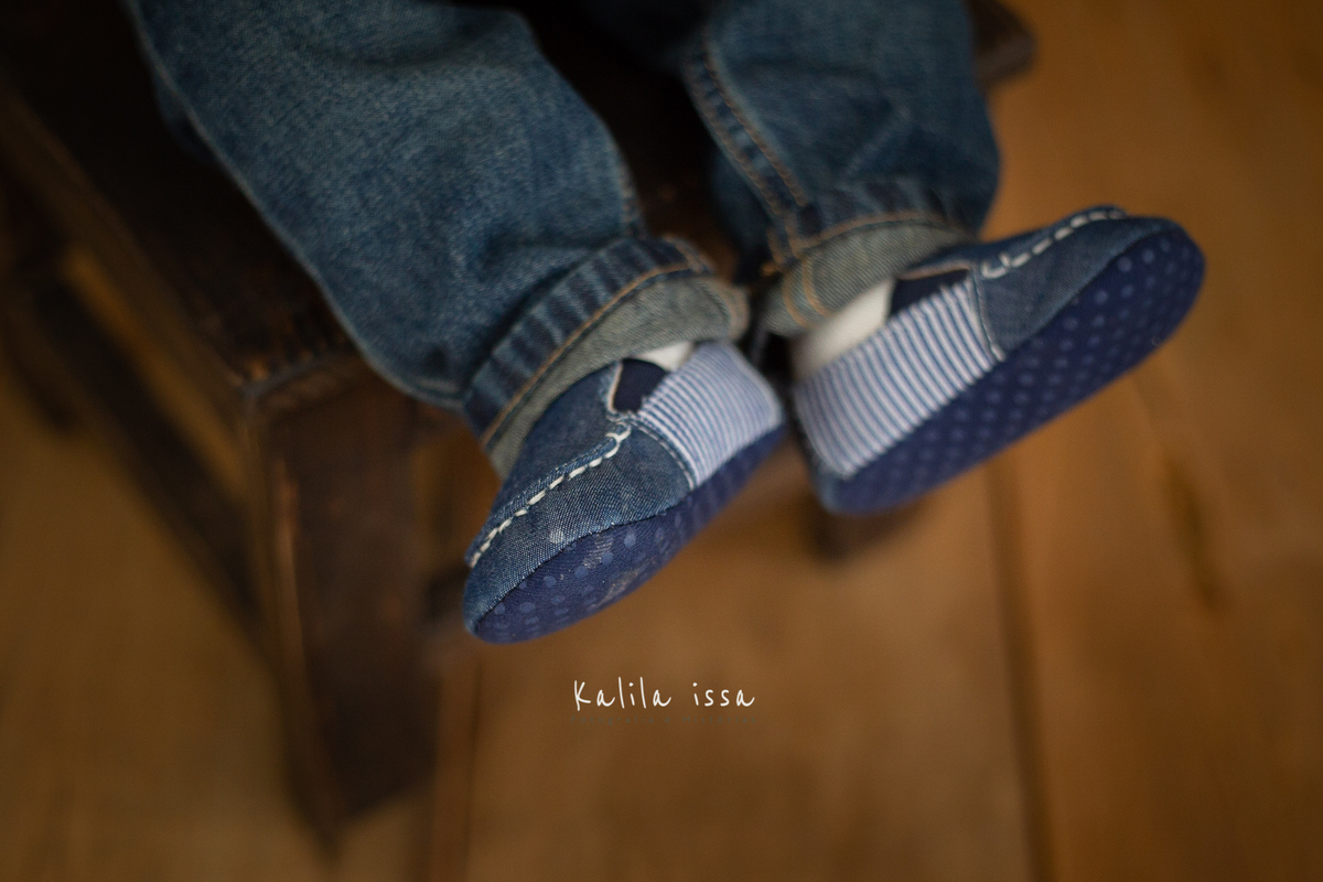 bebê de 8 meses fotografado no estúdio kalila issa usando sapatinho azul 