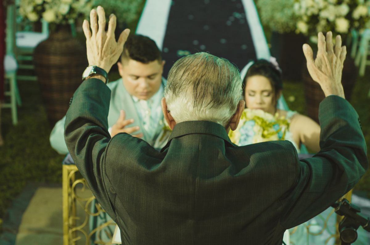 Pastor celebrando casamento, padre, noivos de joelho