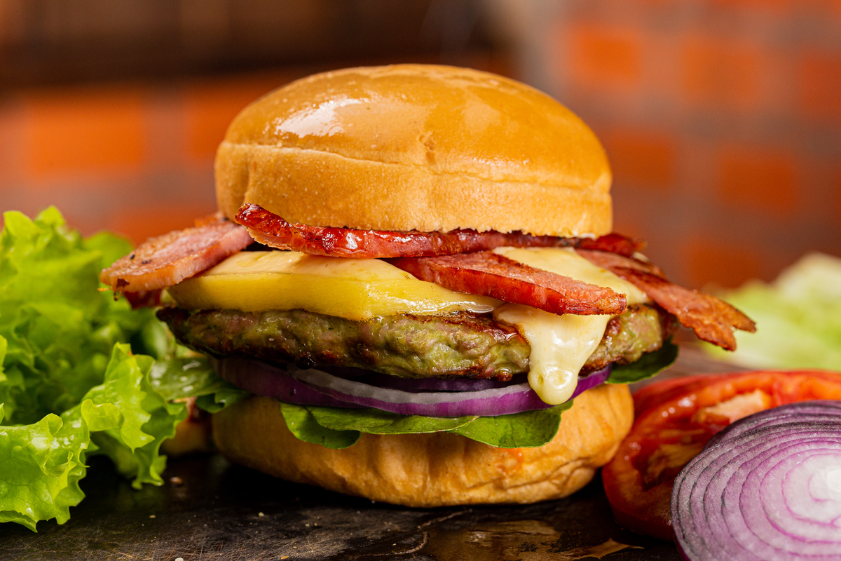 Elizabeth
Hamburguer com 180g de costela angus selecionado, queijo colonial derretido, duplo bacon, rúcula, cebola roxa e molho Queen no pão francês redondo