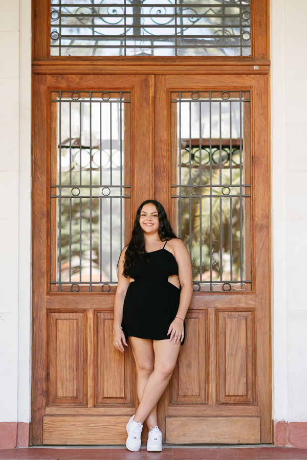 Cenários clássicos: Debutante posando em frente às janelas históricas do sanatório. O charme da arquitetura do Parque Vicentina Aranha nas fotos.