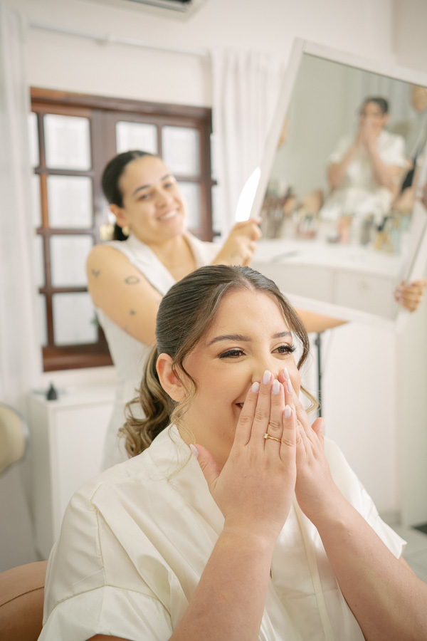 Detalhes emocionantes do vestido de noiva, com a ajuda carinhosa de familiares. Preparação íntima e elegante para a cerimônia civil. Fotos de casamento em Jacareí, Alboom.