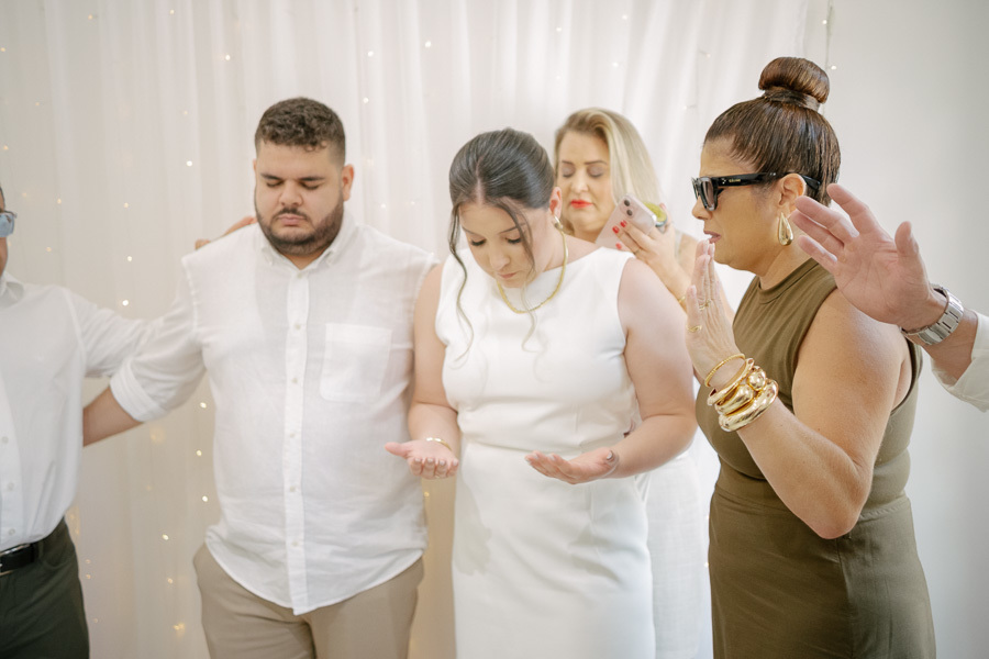 Gesto de carinho: a noiva Giovanna abraçando um familiar ou madrinha. Emoção capturada na celebração do casamento civil.