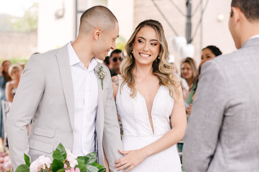 Noivo Luidgi beijando a testa da noiva Aline no altar na Chácara Mariah, em Jacareí. Fotografia de casamento capturando momento de carinho e emoção com convidados ao fundo. Registro profissional por fotógrafo de casamento em Jacareí.