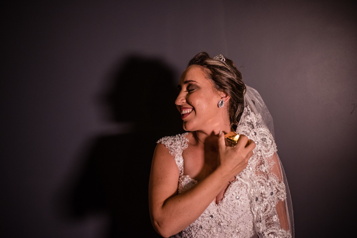 a noiva passando seu perfume no make off