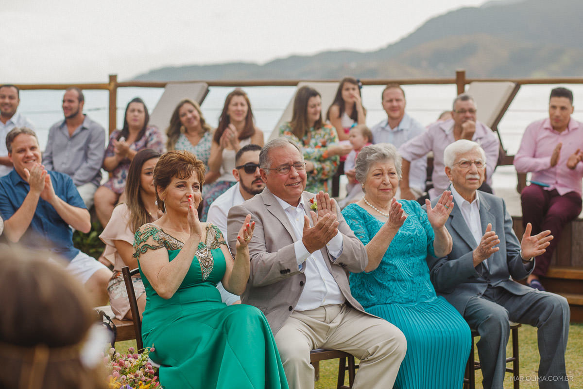Pais e avós aplaudindo os noivos em cerimônia de casamento em Vila das Velas 