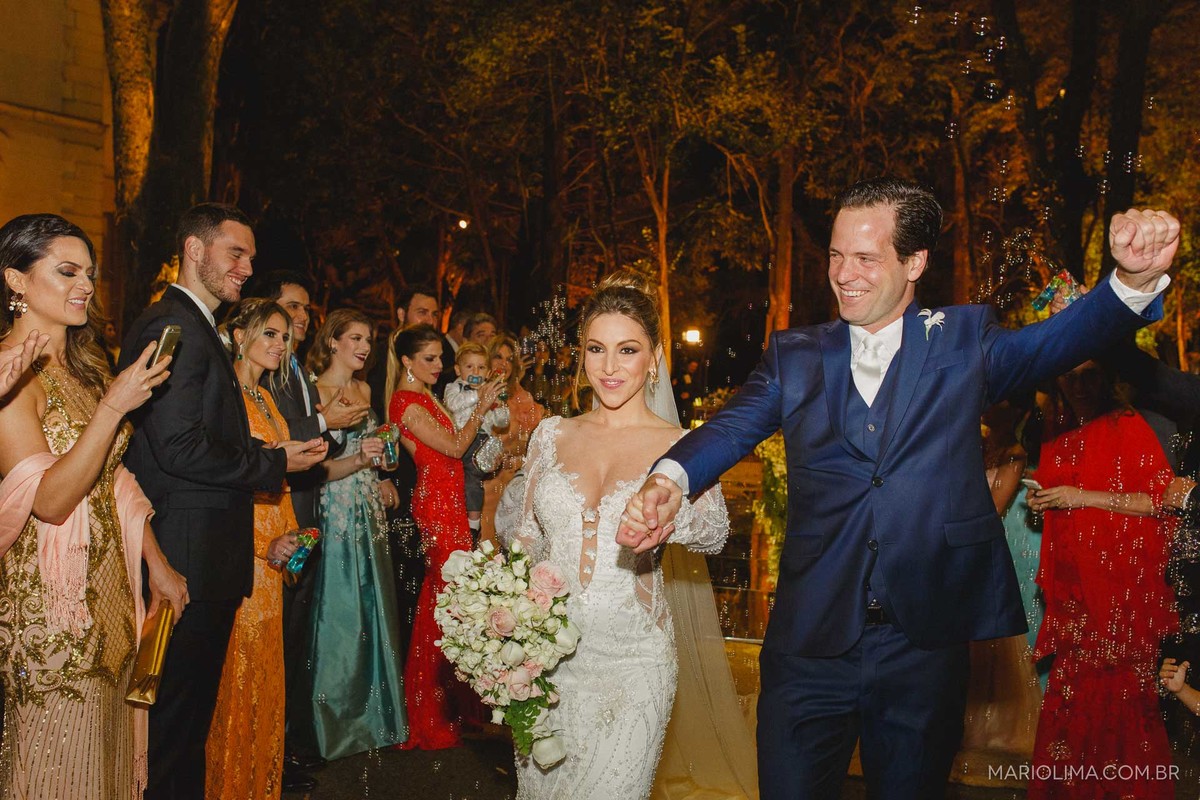 Noivos comemorando em saída do casamento no Iate Clube de Santos em Higienópolis