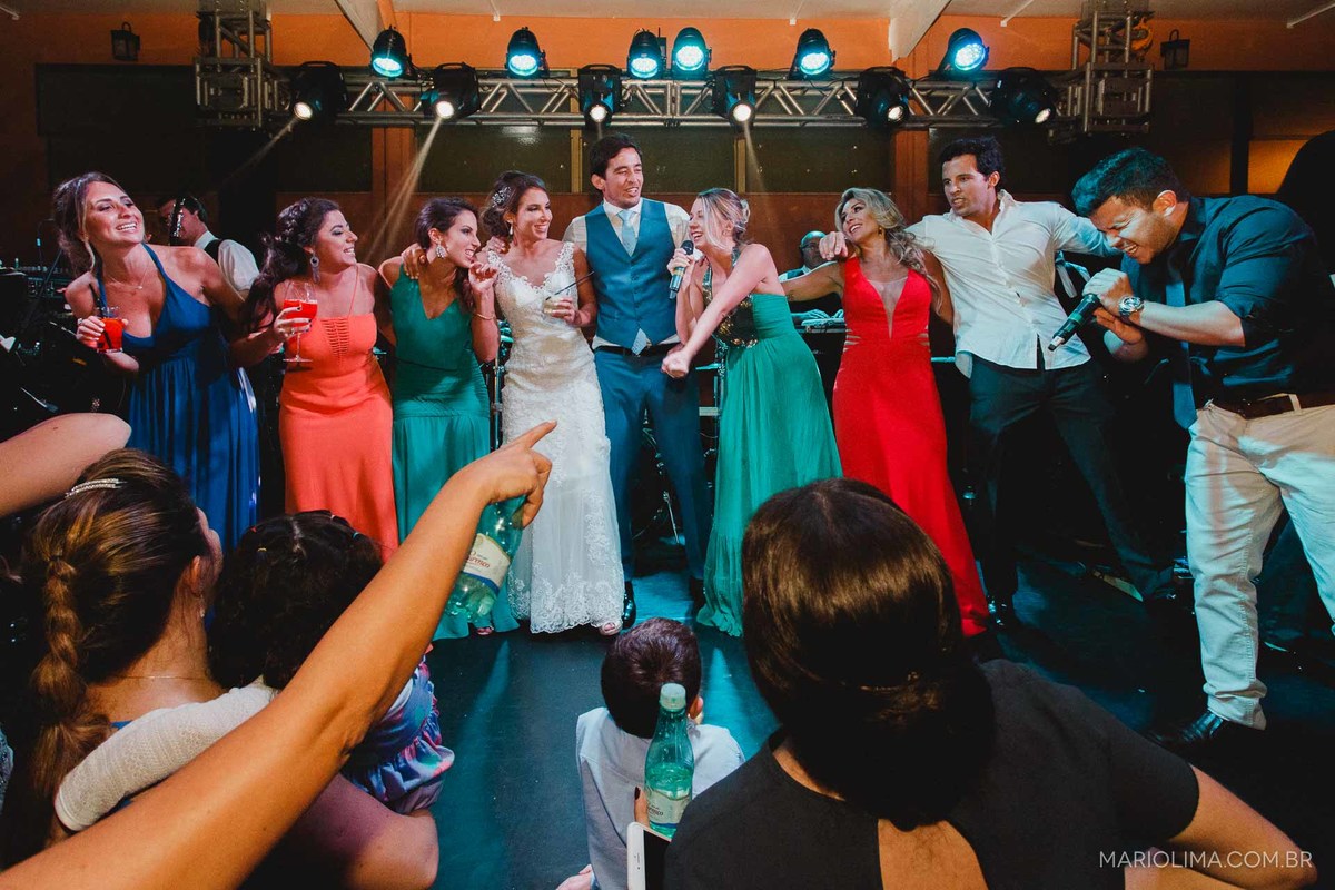 Noivos abraçados com padrinhos e cantando ao som da Banda SP3 em Gare da Mata em São Roque - SP