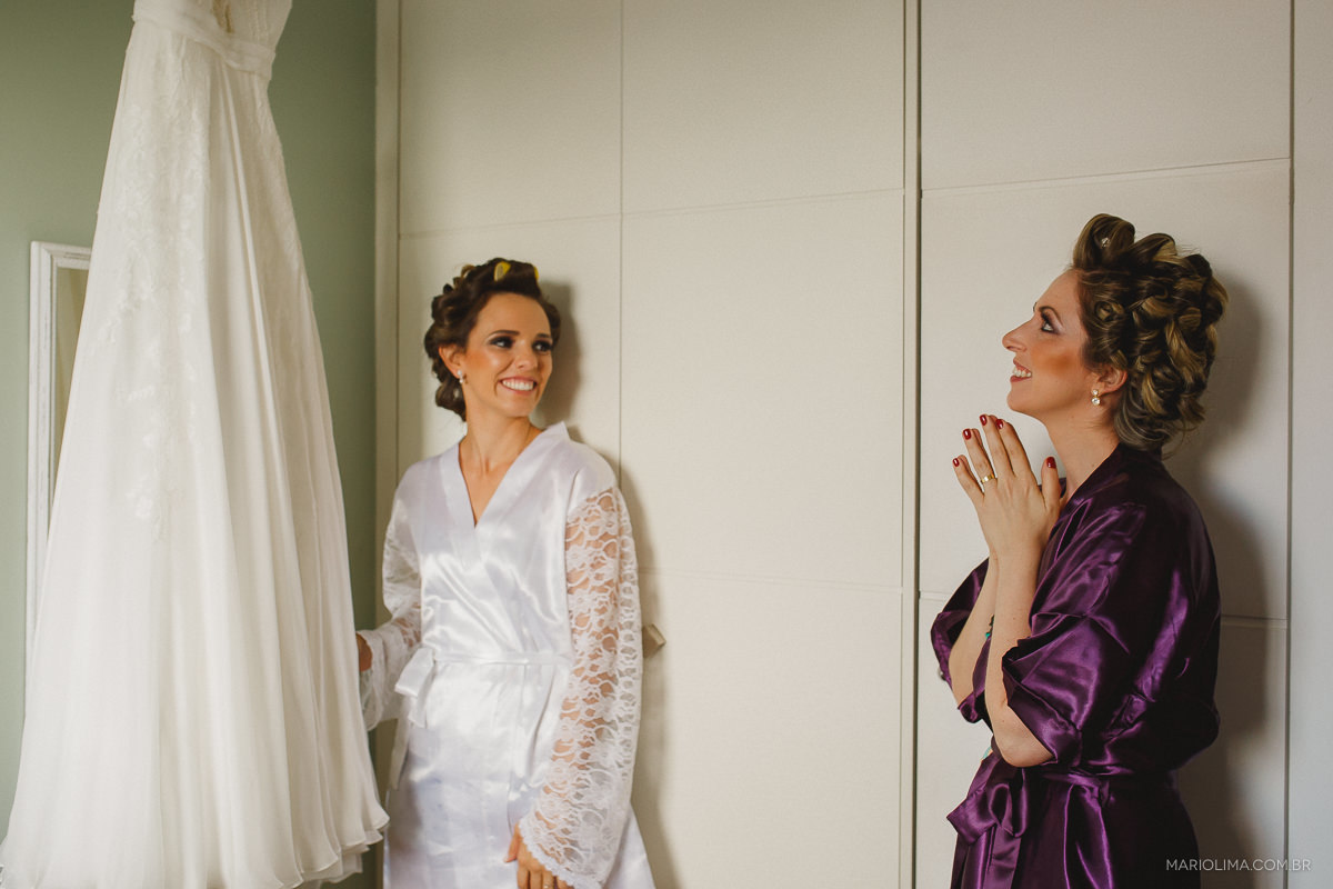 Fotografia de noiva mostrando vestido feito por Emannuelle Junqueira para madrinha 