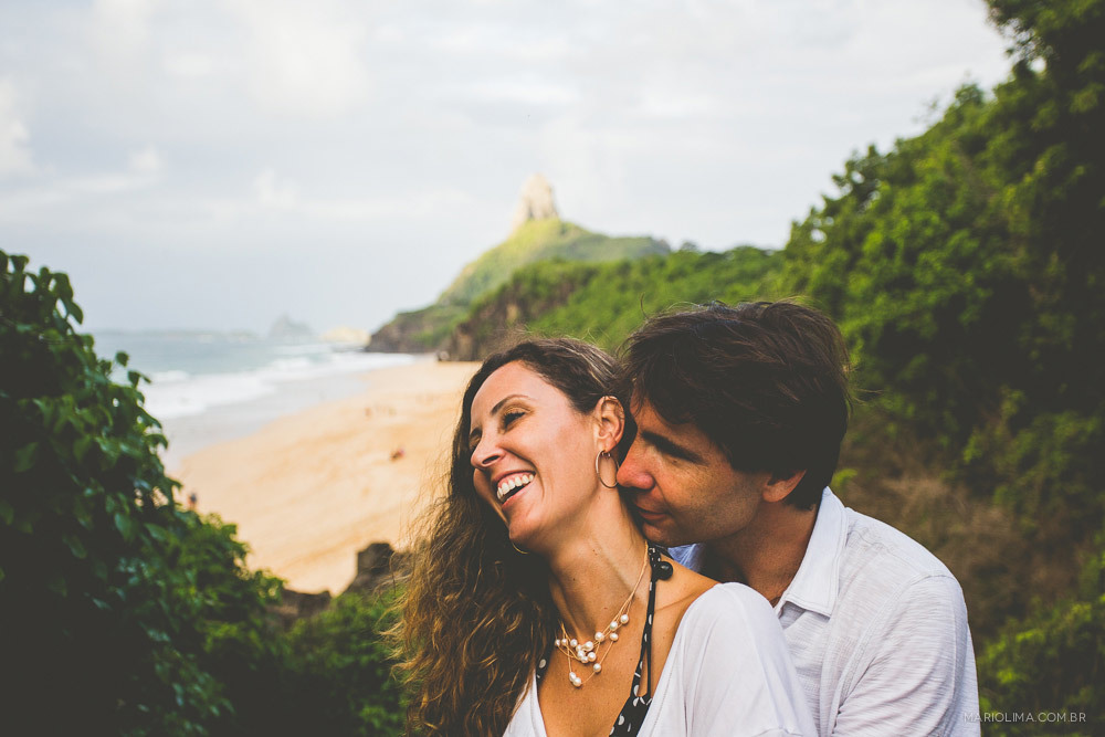 Fotografia de mulher sorrindo ao ser abraçada em Fernando de Noronha