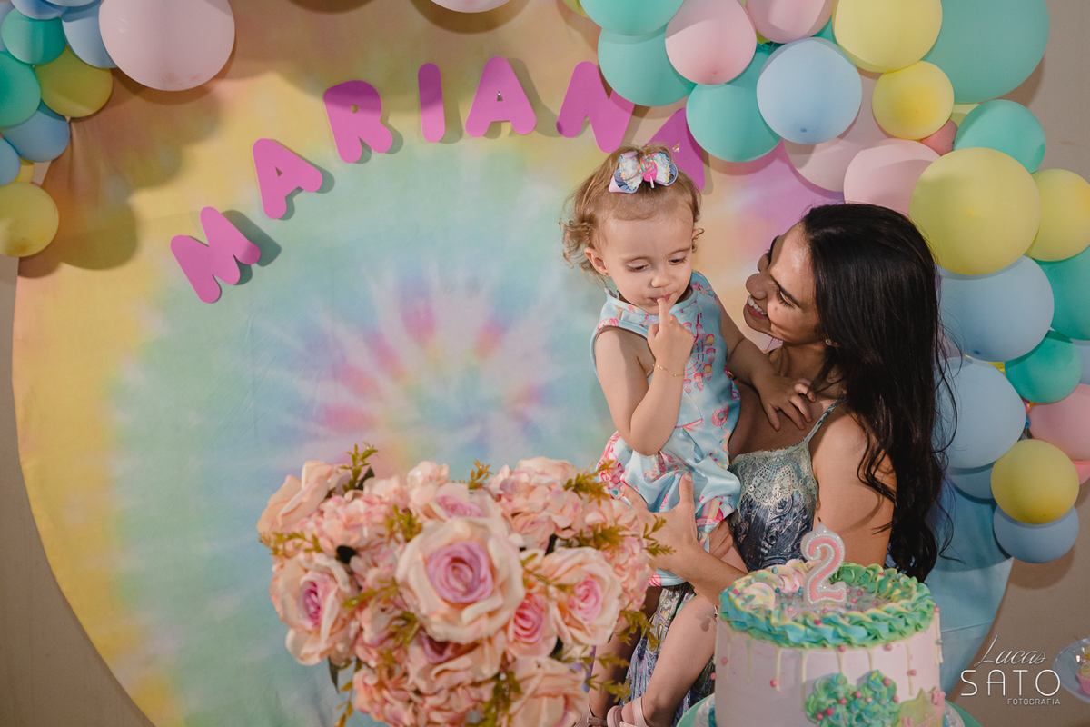 Aniversariante passando o dedo no bolo na festa infantil de 2 anos