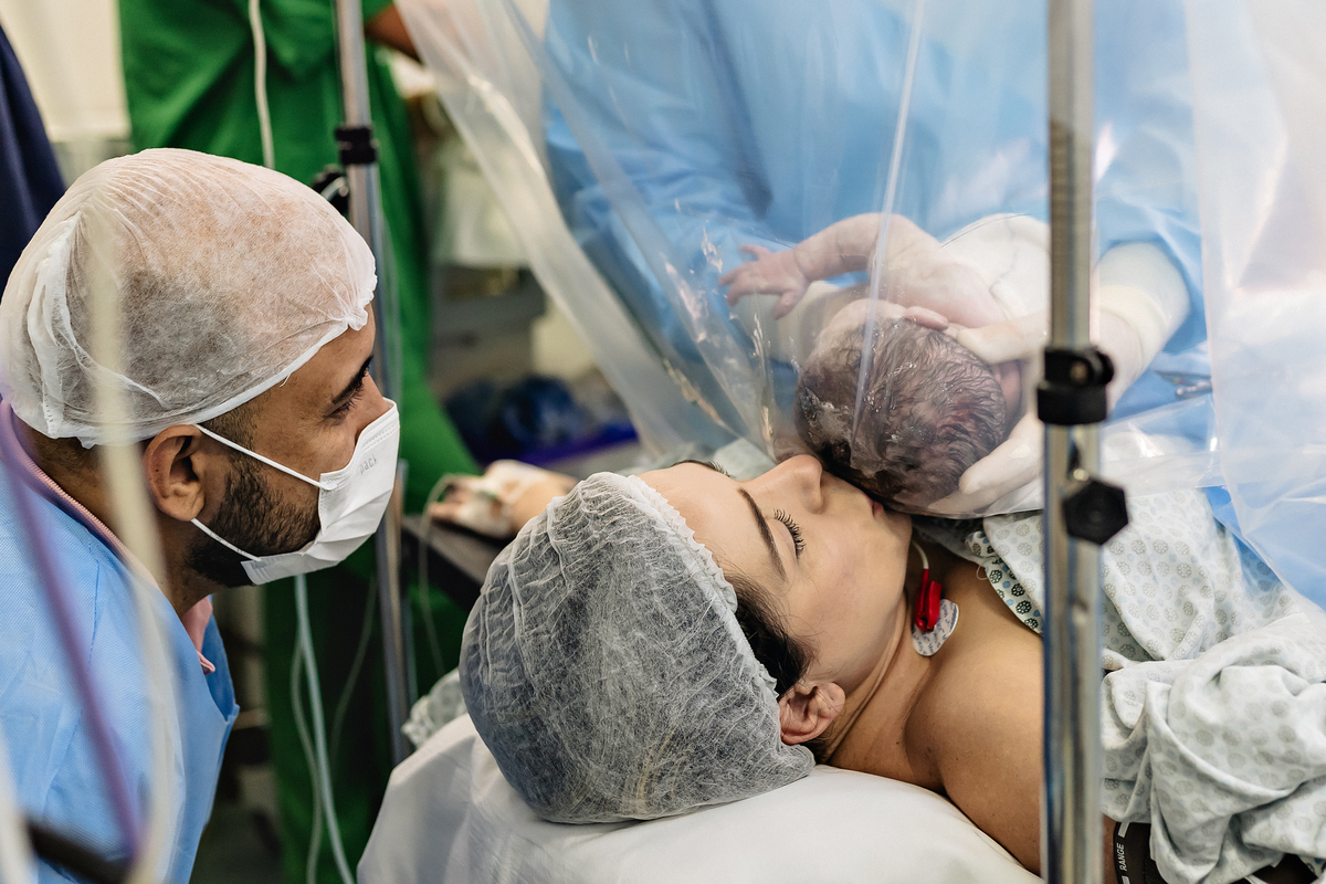 Fotografia de parto cesárea na Unimed Volta Redonda: Nascimento da Rebeca, acompanhada pelo obstetra Dr. Ricardo e pediatra Dra. Alanê.