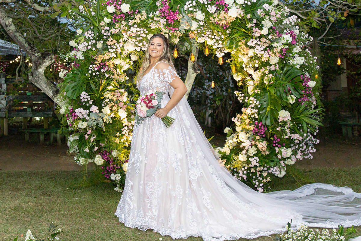 Retrato da  noiva no arco de flores