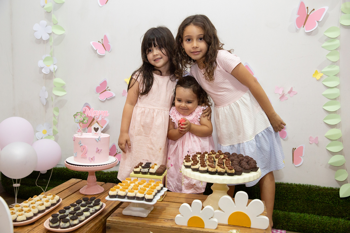 crianças na mesa do bolo comemorando os dois anos da aniversariante