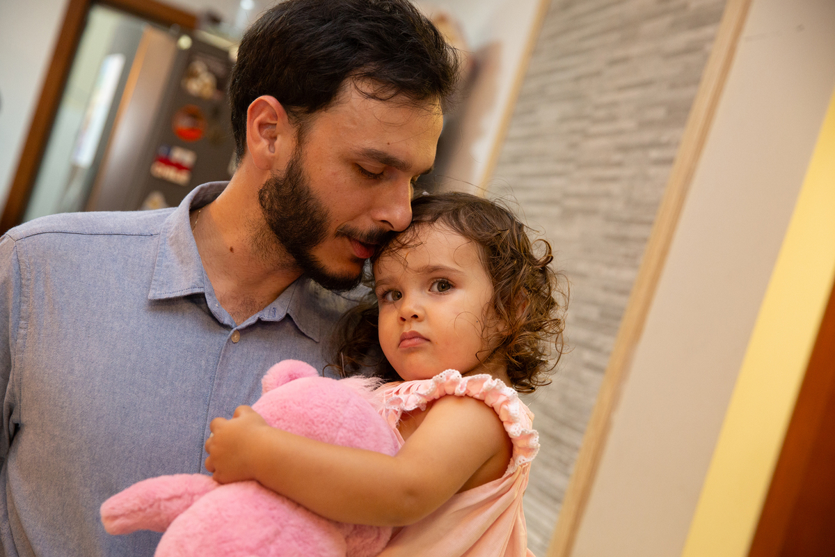 Momento de brincadeira entre crianças pai e filha em festa de aniversario em casa