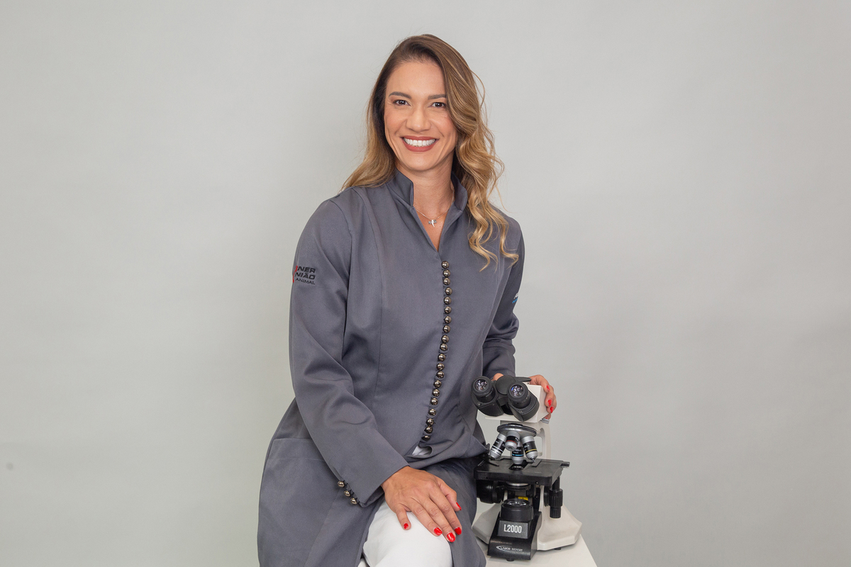 Dra. Aline Galante com jaleco em ensaio corporativo para clínica de dermatologia veterinária.