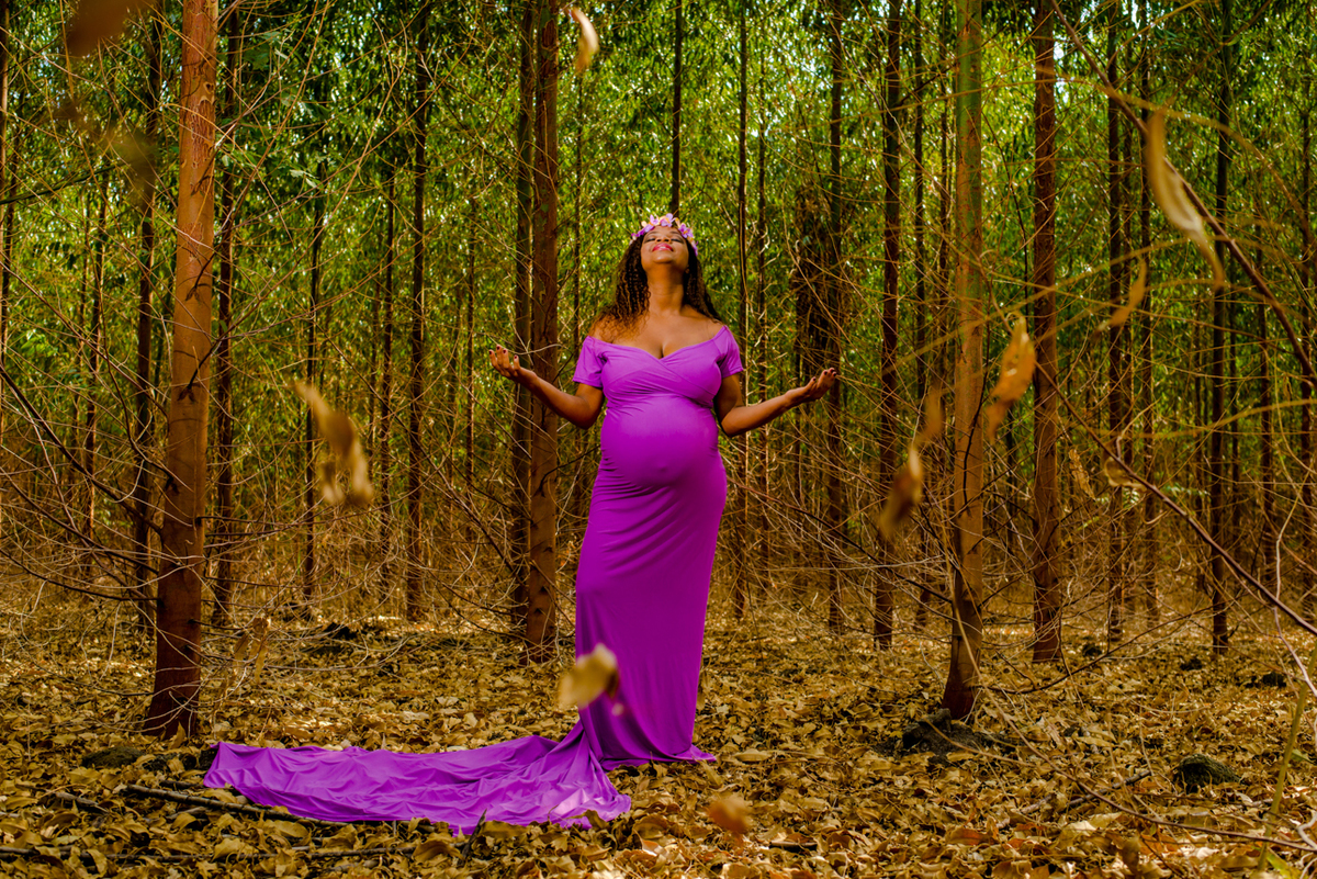 foto gestante em floresta com folhas caindo