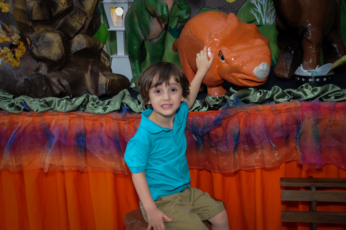 foto do aniversariante com o dinossauro no Buffet Planeta 2, Butantã, SP, festa infantil fotografia infantil, aniversário de Fabrício 4 anos tema da mesa dinossauros